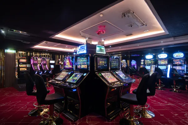 A person using their device against a moody casino-themed background, illustrating the smooth re-entry process at TK555.
